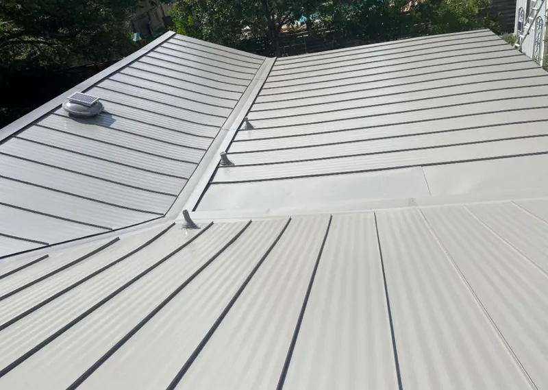 Solar attic fan installed on a metal roof for Roof Ventilation in Birmingham